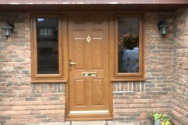 Beautiful UPVC door in wood color with a window on each side.